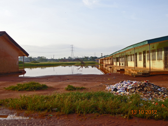 Lectures in progress, under the mercy of mosquitoes and water-borne diseases.: WASH-unfriendly- front of school now a dump site